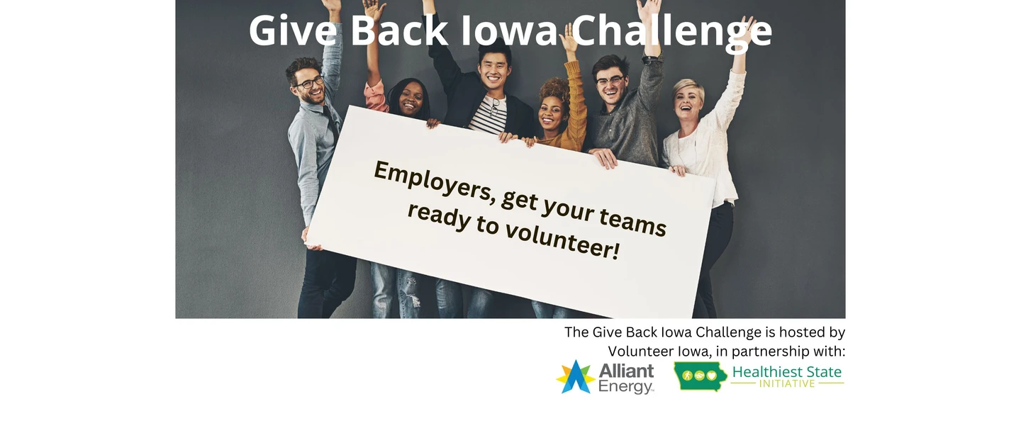 A group of six individuals with their arms raised, holding a sign that says "employers get your teams ready to volunteer!" promoting the Give Back Iowa Challenge.